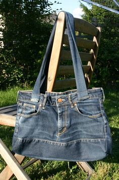 a denim purse sitting on top of a wooden chair