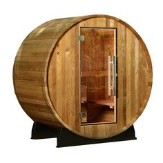 a wooden barrel sauna is shown with its door open to show the inside and outside