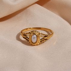 A victorian-inspired beauty and timeless design, the Filigree Pearl Gold Signet Ring is perfect for those special occasions. The lustrous natural pearl is bezel set in a filigree-style signet ring. This gold pearl ring has an heirloom look without the high price tag. DETAILS & SIZE Composition: 18K gold plated over 316L Stainless Steel; Natural pearl Measurements: US ring sizes: 6, 7, 8 Waterproof, tarnish-resistant, and nickel free Learn how to find your ring size here. Read about how to care f Classic Gold Pearl Drop Ring, Classic Gold Pearl Ring With Pearl Drop, Vintage Yellow Gold Pearl Ring, Heirloom Style Gold Pearl Open Ring, Ornate Gold Signet Ring For Formal Occasions, Elegant Signet Ring With Intricate Design For Anniversary, Vintage Gold Signet Ring With Intricate Design, Heirloom Gold Pearl Open Ring, Victorian Gold Signet Ring For Wedding