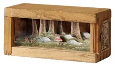 a wooden box with miniature figurines in it