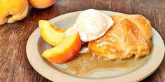 a plate with some food on it and peaches in the back ground next to them