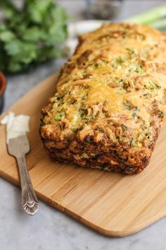 a loaf of bread sitting on top of a wooden cutting board