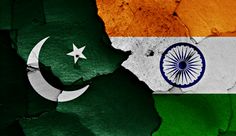 the flag of india and pakistan painted on cracked pieces of green, white and yellow