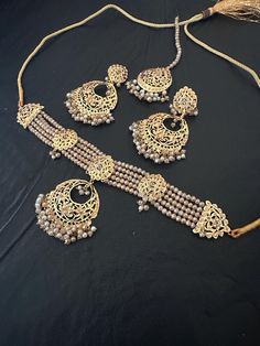 All that glitters is JEWELRY!! And you have to shine by looking like a gem! Order now this beautiful and lightweight Hyderabadi champagne stones choker necklace , drop earrings and mang tikka set perfect for any special occasions. In stock and ready to ship. Set included: necklace ,earrings tikka Color : champagne  Note :Color, shades, texture displayed may slightly vary from the actual product due to digital image limitations. We request you to consider these minor variations. Please expect the possibility of some slight imperfections when buying handmade jewelry. If you have any questions, please contact us. Care instructions : Jewelry caring is a very important part once you use them on a regular basis. We advise you to do the following things to keep them lasts longer: Keep your jewelr Gold Chandbali Jewelry Sets, Gold Jewelry Sets With Stone Work For Eid, Festive Gold Jewelry Set With Stone Work, Gold Plated Chandbali Jewelry Sets, Gold Kundan Jewelry Sets For Eid, Bollywood Style Gold Jewelry With Stone Work, Festive Gold Plated Chandbali Jewelry Sets, Festive Chandbali Gold Plated Jewelry Sets, Festive Bollywood Gold Plated Jewelry Sets