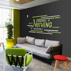 an office with chalkboard walls and colorful chairs in the corner, along with two couches