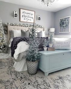 a bedroom decorated for christmas with white and gray decor