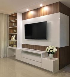 a large flat screen tv mounted to the side of a wall in a living room