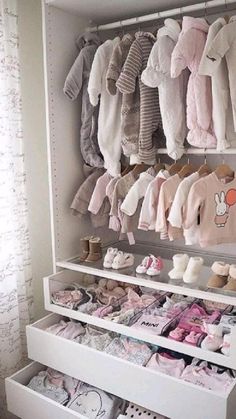 a baby girl nursery closet filled with lots of clothes and shoes for babies to wear