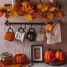 there are many pumpkins and other decorations on the mantle