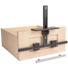 a wooden box with a ruler on top of it and some tools in front of it