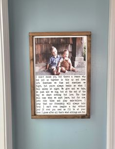 an old photo is hung on the wall above a toilet in a bathroom with blue walls