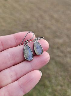 These dangle gemstone earrings feature beautifully flashy rose cut labradorite gemstones dangling from matching handcrafted argentium silver ear wires. The gemstones have been carefully set into handmade argentium silver bezel cups and the pieces have been given a lightly oxidized finish.  These earrings measure approximately 1.25in long x 8mm wide at their widest point.  Follow this link to see my shop: https://www.etsy.com/shop/barebranchjewelry Follow these link to see some of my other gemstone pieces: North star earrings: https://www.etsy.com/listing/1417865688/teal-kyanite-north-star-earrings-teal Orange kyanite ring: https://www.etsy.com/listing/1341334389/orange-kyanite-ring-orange-gemstone-ring Teal Kyanite sunset earrings: https://www.etsy.com/listing/1432075707/moss-teal-kyanite- Nickel-free Labradorite Drop Earrings, Teardrop Labradorite Earrings, Handmade Long Drop Labradorite Earrings, Handmade Labradorite Teardrop Earrings, Labradorite Teardrop Earrings As Gift, Labradorite Teardrop Earrings For Gift, Silver Earrings Simple, Orange Kyanite, Gemstone Earrings Dangle