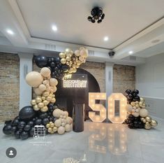 a 50th birthday party with balloons and lights