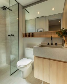 a bathroom with a toilet, sink and shower