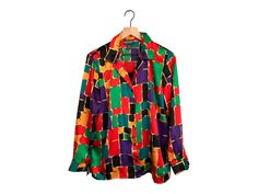 "Vintage 90s abstract bold primary colors blouse- has a matching \"tank\" built in. This blouse is so silky and luxurious!  Label: Notations Clothing Company Size: M Made in Hong Kong Measures 27\" long, 17\" shoulder to shoulder, 20.5\" armpit to armpit, 23\" long sleeves. Condition: No flaws to report!" Silk Tops With Multicolor Graphic Print, Multicolor Silk Top With Vibrant Print, Multicolor Silk Tops With Vibrant Print, Silk Graphic Print Multicolor Tops, Silk Multicolor Graphic Print Tops, Casual Silk Tops With Vibrant Print, Multicolor Silk Tops With Graphic Print, Fitted Multicolor Silk Shirt, Vintage Multicolor Silk Tops