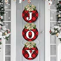 joy christmas door banner with poinsettis and holly on red plaid fabric hanging from the front door