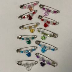 a bunch of different colored hair clips on a white surface