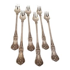 six silverplated forks and spoons with ornate designs on the handles, all in different sizes