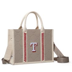 Officially Licensed Major League Baseball Merchandise Made of synthetic leather Embossed T logo on the front All-over embossed T logo pattern Red stitching detail Top zipper closure A zip pocket and a snap-button closure on the back pocket Adjustable and detachable crossbody strap(Drop: 17"-28.8") 12.8"(L) x 4.8"(W) x 9.5"(H) Interior Capacity: Large Beige Shoulder Bag With Embroidered Logo And Double Handle, Brown Bags With Embroidered Logo For Shopping, Leather Shopping Bag With Embroidered Logo, Leather Shoulder Bag With Embroidered Logo For Travel, Brown Travel Bag With Embroidered Logo, Leather Shoulder Bag With Embroidered Logo For Shopping, Leather Shoulder Bag With Embroidered Logo For Everyday Use, Everyday Leather Shoulder Bag With Embroidered Logo, Leather Travel Bag With Contrast Stitching