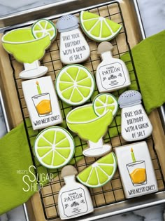 decorated cookies with lemons and lime slices on a cooling rack for serving to guests