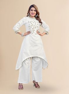 Introducing our exquisite white embroidered kurta with gold embroidery, a perfect blend of elegance and style. Crafted from pure linen fabric, this kurta pant set for women showcases intricate gold embroidery that adds a touch of opulence to its pristine white color. The cowry design and mendarian neck further enhance its unique appeal, while the high-low kurta design and elasticated pant ensure a comfortable and flattering fit. Embrace the beauty of traditional craftsmanship with this stunning ensemble.  Kurta design :- Floral embroidered A-line shape Regular style Mandarin collar Three-quarter, regular sleeves 2 pockets thread work detail Calf length length with asymmetric hem Linen knitted and woven fabric Palazzos design :- Solid palazzos Partially elasticated waistband Slip-on closure Kurta Pant Set, Kurta Style, Kurta Design, Kurta With Pants, Gold Embroidery, Kurta Designs, Thread Work, Kurta Set, Pant Set