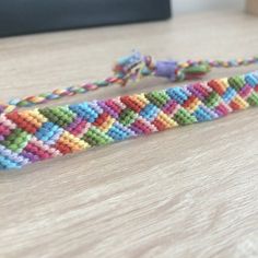 there is a multicolored beaded bracelet on the table