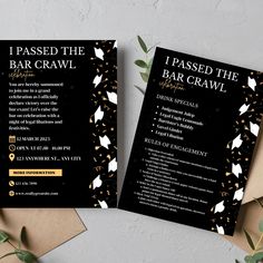 two black and gold bar crawls on top of brown envelopes with greenery