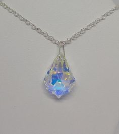 This beautiful clear Aurora Borealis AB Swarovski crystal baroque drop hangs on a sterling silver chain.**Crystal Clear AB (Aurora Borealis) is a shimmering, iridescent rainbow effect that creates an even greater sparkling quality to the base color and reflects varying colors depending on the angle of light. Pick you chain:15" Cable, 18” Cable, 20” Cable, or 20” SnakePendant Size: 22x15mmNecklace is packaged in a white cotton-filled gift box.**Matching Earrings Available**https://www.etsy.com/Su Silver Pendant Crystal Necklace With Jewels, Teardrop Crystal Necklace Gift, Teardrop Crystal Necklace For Gift, Crystal Necklace With Teardrop Pendant For Gift, Gift Teardrop Crystal Necklace, Faceted Drop Silver Crystal Necklaces, Silver Faceted Drop Crystal Necklaces, Silver Fantasy Crystal Necklace Gift, Elegant Handmade Iridescent Crystal Necklace