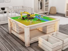 a table that is made out of wood and has construction vehicles on it, sitting on the floor