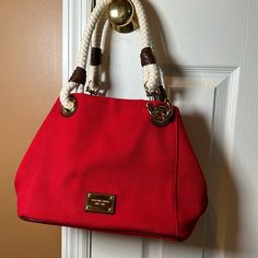 Beautiful Canvas Michael Kors True Red With Rope Handles, Leather Detail Anchor Style With Gold Hardware. 4 Pockets And One Larger Zip Pocket 12” Across Bottom 9” Deep Designer Red Bags With Leather Trim, Elegant Red Bags With Leather Trim, Michael Kors Tote Bag With Leather Trim, Michael Kors Leather Trim Tote Bag, Red Bag With Braided Handles For Errands, Red Rectangular Shoulder Bag With Leather Trim, Luxury Red Shoulder Bag With Leather Trim, Red Leather Trim Satchel Bag, Red Shoulder Bag With Braided Handles For Errands