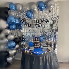 a birthday party with balloons, cake and decorations