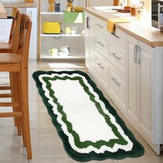 a green and white rug in the middle of a kitchen