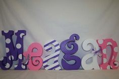 the letters are made out of wood and have polka dot designs on them, as well as numbers