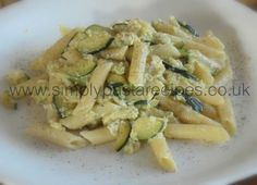 pasta with zucchini and sauce on a white plate