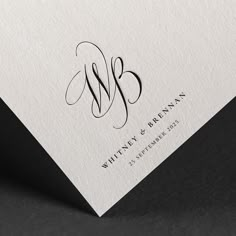 the monogramed letter w is shown on top of a white card with black ink