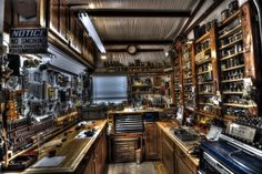 an old fashioned shop with lots of tools and other items on the shelves in it