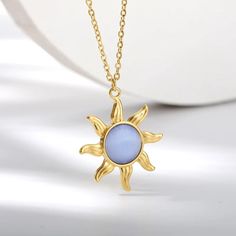 Symphony of Light: The Opal Sun Necklace Embrace the harmony of nature with the Symphony of Light Necklace. Crafted from polished stainless steel with a warm gold finish, this necklace offers a captivating blend of vintage elegance and celestial inspiration. The centerpiece is a stunning sun pendant, its intricate details capturing the radiant essence of the sun. A touch of magic is added by the opal gemstone nestled in the center, its iridescent play of color reflecting a symphony of light. Lig Rose Gold Spiritual Necklace, Gold Celestial Necklace With Polished Finish, Celestial Stainless Steel Necklace For Gifting, Celestial Stainless Steel Necklaces As Gift, Celestial Stainless Steel Necklace As Gift, Celestial Stainless Steel Necklace For Gift, Celestial Style Stainless Steel Necklace For Gift, Gold Polished Stainless Steel Necklace, Yellow Gold Polished Stainless Steel Necklace