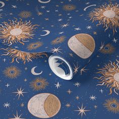 the sun, moon and stars wallpaper is shown in black with gold foil on it