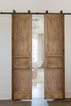 an open wooden door in a white room