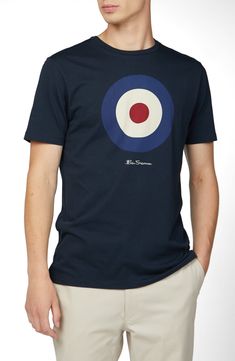 Ben Sherman's iconic target logo pops front and center on a T-shirt made for comfort from soft, breathable organic cotton. Crewneck Short sleeves 100% organic cotton Machine wash, tumble dry Imported Cotton T-shirt With Front Logo, Cotton T-shirt With Front Logo In Relaxed Fit, Relaxed Fit Cotton T-shirt With Front Logo, Sporty Cotton T-shirt With Front Logo, Retro Crew Neck Top In Organic Cotton, Retro Organic Cotton Crew Neck Top, Cotton Crew Neck Tops With Front Logo, Cotton Tops With Front Logo And Relaxed Fit, Arrow Target