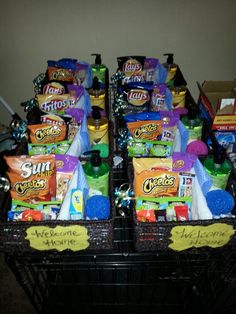 two baskets filled with snacks and condiments on top of a floor next to a wall