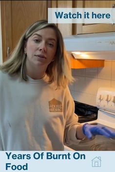 a woman in a white shirt and blue gloves is holding a pan with food on it