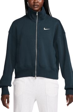 An oversized fit and dropped shoulders add to the coziness of this sporty, midweight fleece track jacket accented with a wide ribbed hem and embroidered Swoosh. 21 1/2" length (size Medium) Two-way front-zip closure Stand collar Dropped shoulders Front welt pockets Ribbed cuffs and hem 80% cotton, 20% polyester Machine wash, tumble dry Imported Sporty Activewear For Fall Streetwear, Oversized Functional Sweatshirt For Fall, Nike Track Jacket For Sports Season In Athleisure Style, Nike Athleisure Track Jacket For Sports Season, Sporty Oversized Activewear For Winter, Oversized Sporty Winter Activewear, Oversized Sporty Activewear For Winter, Nike Athleisure Track Jacket, Sporty Fleece Jacket For Streetwear