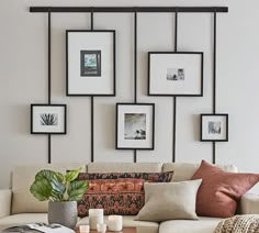 a living room filled with lots of furniture and pictures on the wall above it's coffee table