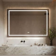 a bathroom with a large mirror above the sink