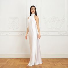 With its modern yet timeless appeal, the Jasmine Halterneck Silk Dress showcases Il Volo’s elevated approach to ready-to-wear. Crafted from white double silk satin in a flattering bias cut, it drapes elegantly over the silhouette. For a playful and feminine look, you can transform the silk tie neck into a chic bow, or you can let it drape loosely, adding a touch of laid-back sophistication to your ensemble.  Wear it with flats for an effortlessly refined look or dress it up with a precious pair White Satin Finish Slip Dress For Evening, Elegant White Slip Dress For Formal Occasions, Elegant White Satin Maxi Dress, Elegant White Formal Slip Dress, Elegant White Satin Dress For Formal Occasions, Chic White Satin Formal Dress, White Satin Cocktail Slip Dress, White Satin Slip Dress For Cocktail, White Silk Satin Evening Dress