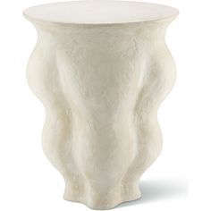 a white vase sitting on top of a table