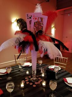 a table set up with cards and wine glasses for an elegant dinner or casino party