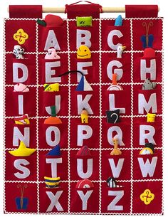 a red wall hanging with letters, numbers and faces on it's sides to spell out the alphabet