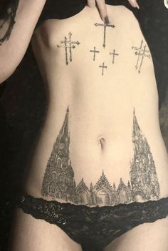 a woman with cross tattoos on her stomach